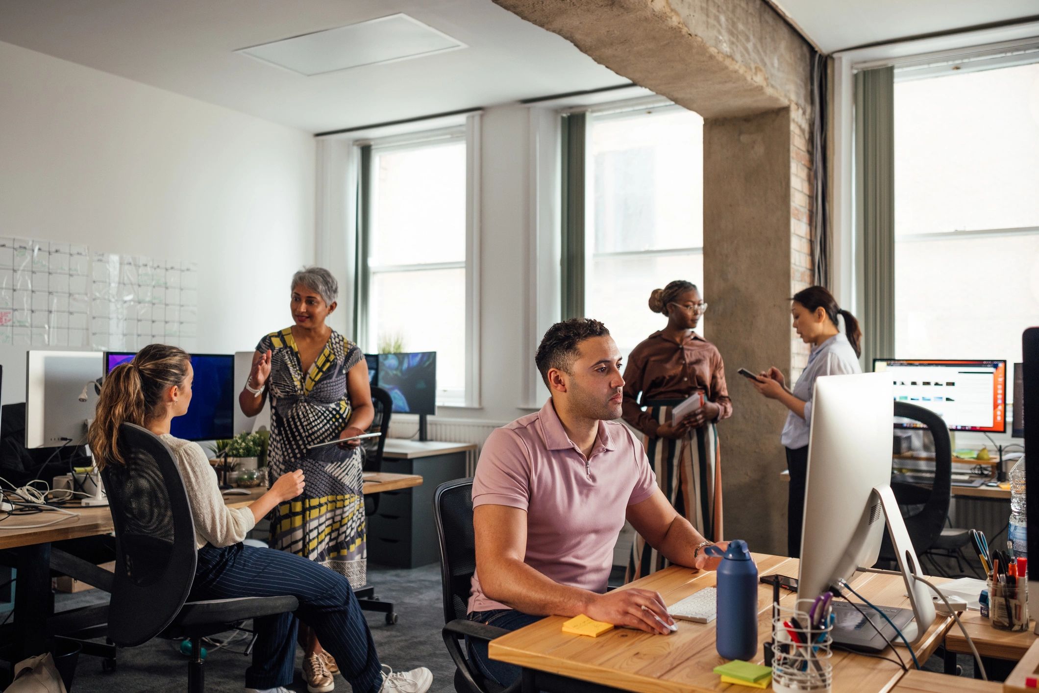 Professionals collaborating in a modern technology office